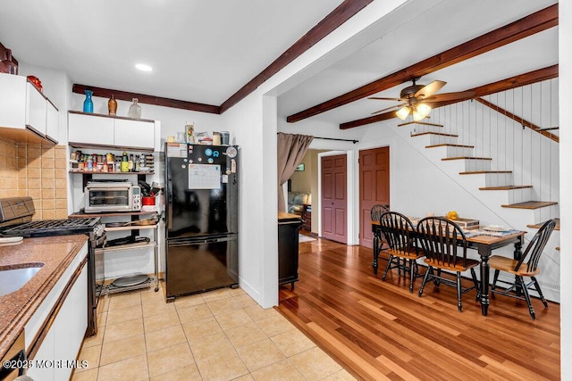 908 Green Grove Rd, Ocean Twp, NJ 07712 - kitchen with freestanding refrigerator, range with gas stovetop, white cabinetry, a ceiling fan, and backsplash