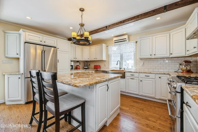13 Poplar Ave, Fair Haven, NJ 07704 - kitchen featuring appliances with stainless steel finishes, a wall mounted air conditioner, a sink, white cabinetry, and recessed lighting