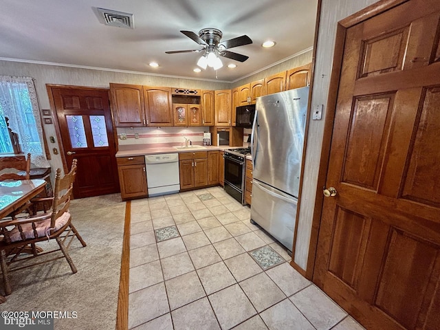 504 Windsor St, Forked River, NJ 08731 - kitchen with black appliances, a sink, a ceiling fan, crown molding, and light countertops