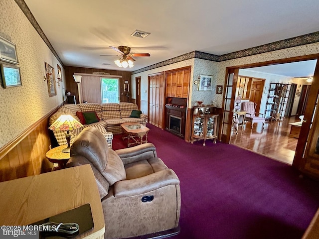 504 Windsor St, Forked River, NJ 08731 - living area with wallpapered walls, a ceiling fan, a fireplace, carpet, and crown molding