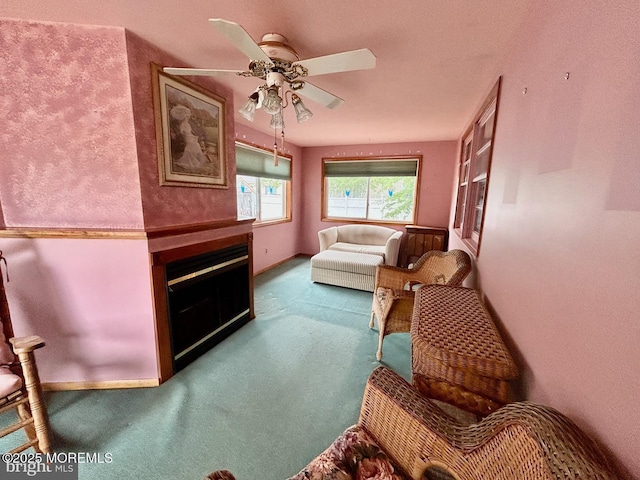 504 Windsor St, Forked River, NJ 08731 - sitting room with carpet, a glass covered fireplace, a ceiling fan, and baseboards