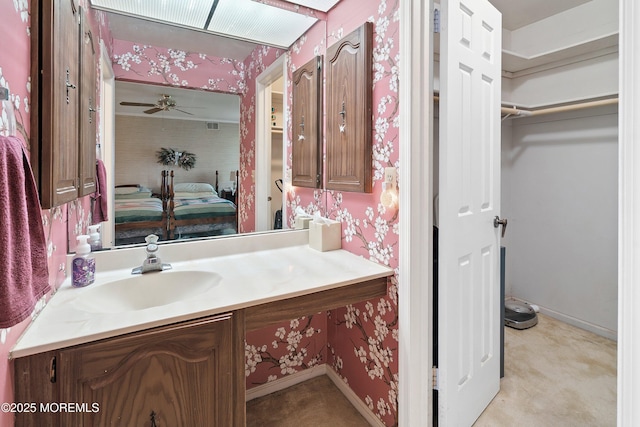 4 Olympus Way, Brick, NJ 08724 - bathroom featuring vanity, wallpapered walls, ceiling fan, a spacious closet, and baseboards