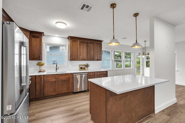 85 Central Blvd, Brick, NJ 08724 - kitchen featuring stainless steel appliances, a sink, decorative backsplash, and light countertops