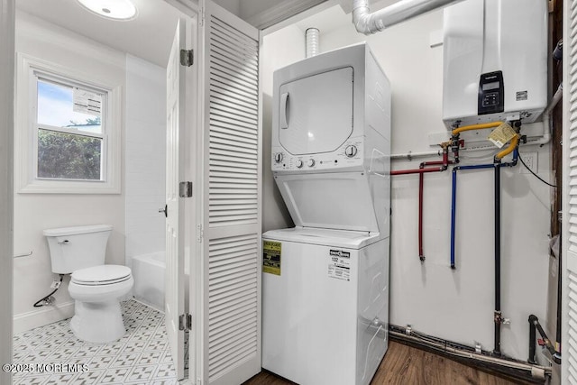 85 Central Blvd, Brick, NJ 08724 - laundry area with stacked washer and clothes dryer, tankless water heater, and baseboards