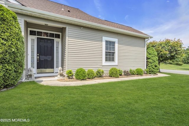 46 Pancoast Rd, Waretown, NJ 08758 - view of exterior entry featuring a lawn and roof with shingles