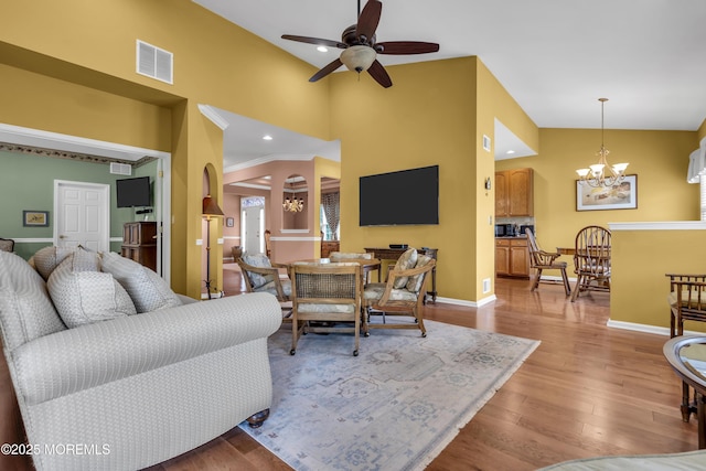 46 Pancoast Rd, Waretown, NJ 08758 - living area featuring a chandelier, wood finished floors, ceiling fan, baseboards, and a towering ceiling