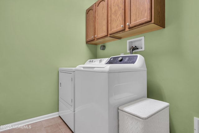 46 Pancoast Rd, Waretown, NJ 08758 - laundry area featuring cabinet space, washer and clothes dryer, baseboards, and light tile patterned floors