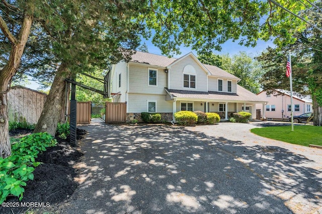 85 Main Bayway, Toms River, NJ 08753 - traditional home with a gate, concrete driveway, stone siding, and a shingled roof