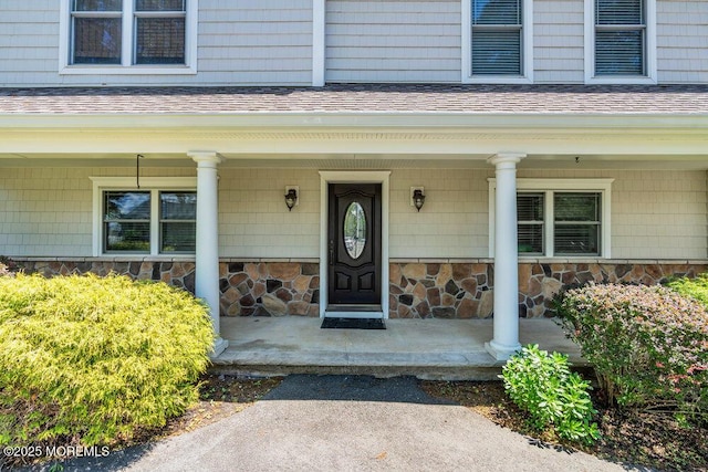 85 Main Bayway, Toms River, NJ 08753 - property entrance with covered porch, a shingled roof, and stone siding