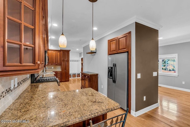 85 Main Bayway, Toms River, NJ 08753 - kitchen with stainless steel appliances, brown cabinetry, crown molding, backsplash, and light wood finished floors