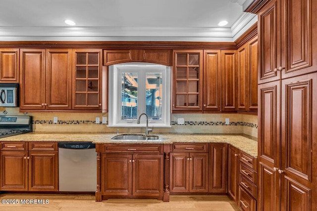 85 Main Bayway, Toms River, NJ 08753 - kitchen featuring stainless steel appliances, a sink, ornamental molding, light stone counters, and glass insert cabinets