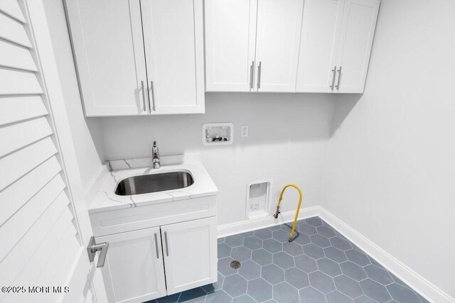 909 Leighton Ave, Point Pleasant, NJ 08742 - laundry area featuring hookup for a washing machine, gas dryer hookup, cabinet space, baseboards, and dark tile patterned floors