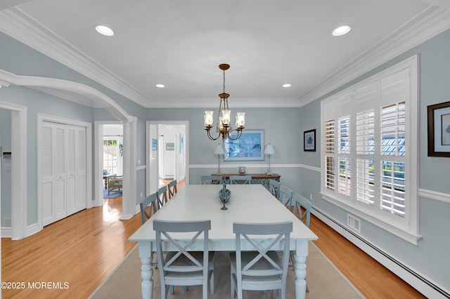 842 E Ave, Bay Head, NJ 08742 - dining room featuring baseboard heating, light wood-style flooring, arched walkways, a chandelier, and ornamental molding