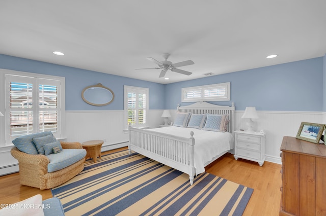 842 E Ave, Bay Head, NJ 08742 - bedroom with a baseboard radiator, a wainscoted wall, wood finished floors, ceiling fan, and recessed lighting
