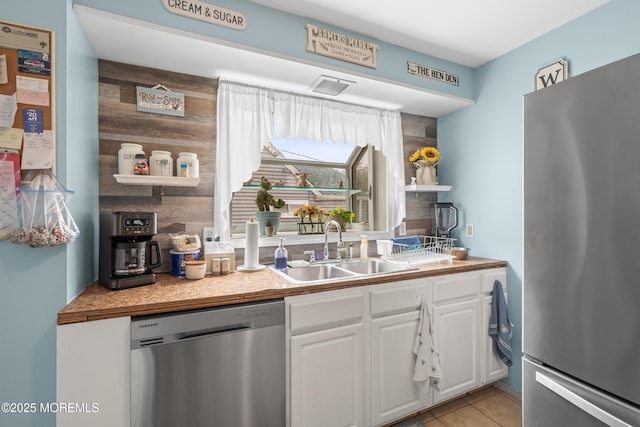 175 W Shore Ave, Bogota, NJ 07603 - kitchen with stainless steel appliances, a sink, white cabinets, open shelves, and light tile patterned floors
