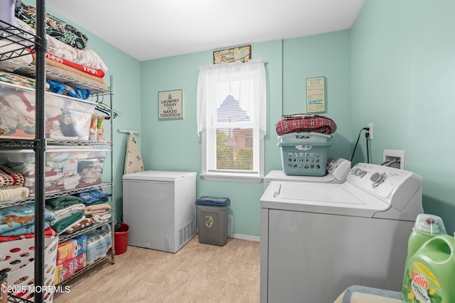 175 W Shore Ave, Bogota, NJ 07603 - laundry area with washing machine and clothes dryer, wood finished floors, and baseboards