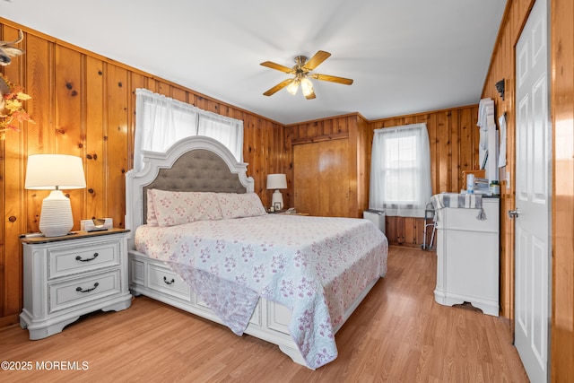 175 W Shore Ave, Bogota, NJ 07603 - bedroom featuring light wood-style floors, wooden walls, and ceiling fan