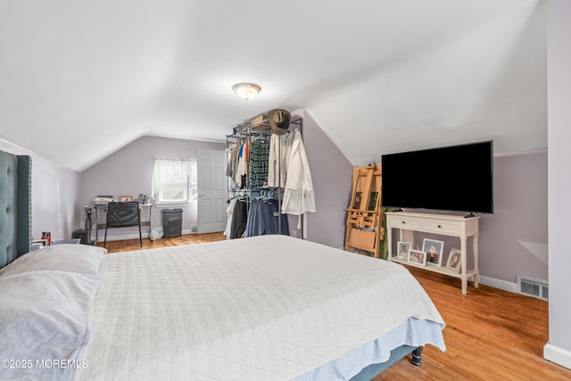 175 W Shore Ave, Bogota, NJ 07603 - bedroom featuring baseboards, light wood finished floors, and lofted ceiling