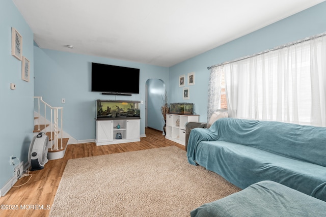 175 W Shore Ave, Bogota, NJ 07603 - living area featuring arched walkways, light wood-style flooring, and baseboards