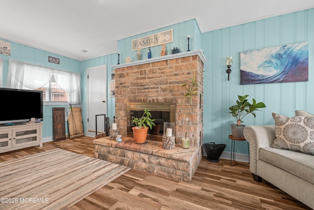 175 W Shore Ave, Bogota, NJ 07603 - living room with wood finished floors, a decorative wall, a brick fireplace, and baseboards