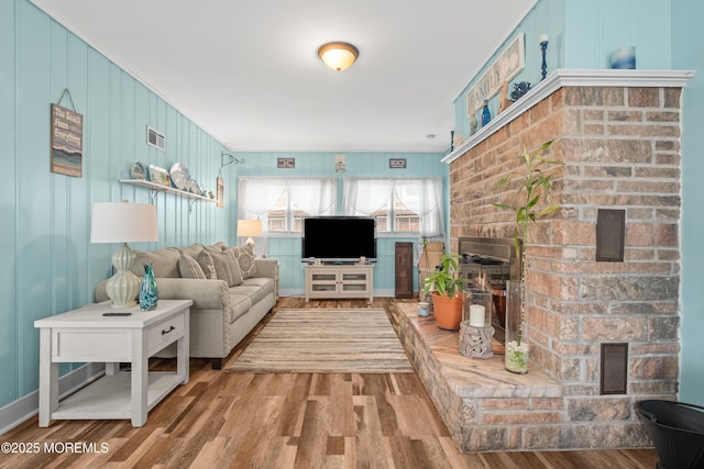 175 W Shore Ave, Bogota, NJ 07603 - living area with wood finished floors, a brick fireplace, and crown molding