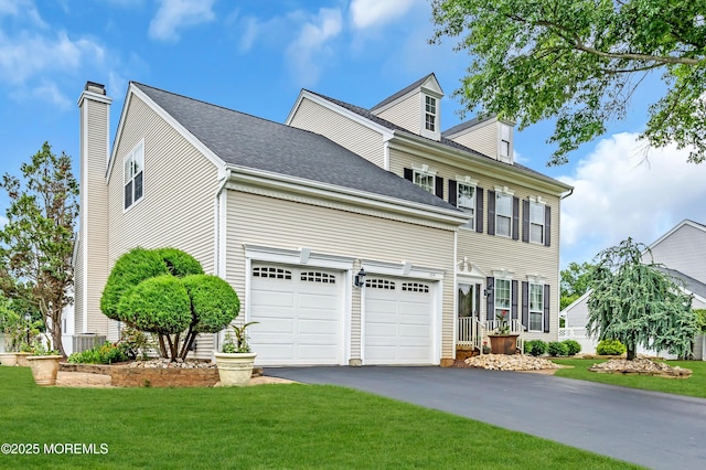 104 Plumstead Dr, Freehold, NJ 07728 - view of front of property featuring asphalt driveway, a front yard, a chimney, and a garage