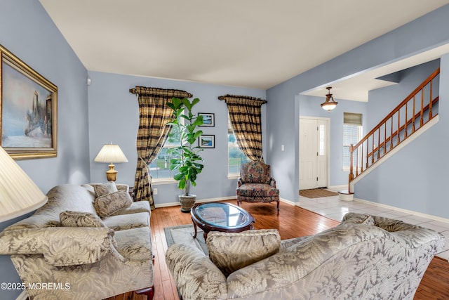 104 Plumstead Dr, Freehold, NJ 07728 - living room featuring stairs, wood finished floors, and baseboards