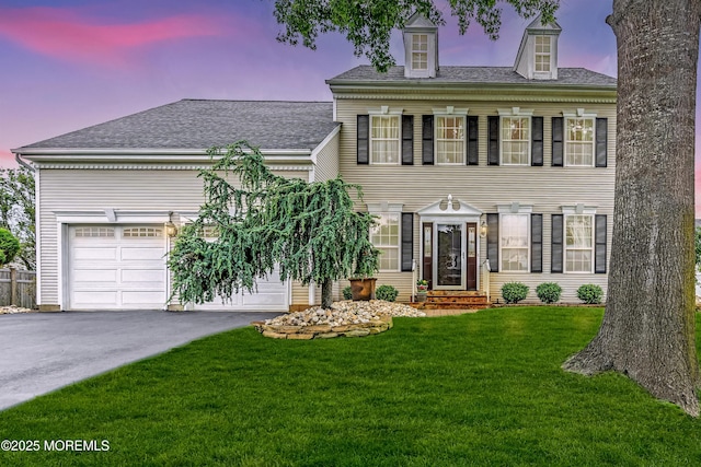 104 Plumstead Dr, Freehold, NJ 07728 - colonial inspired home with entry steps, asphalt driveway, a front lawn, and a shingled roof