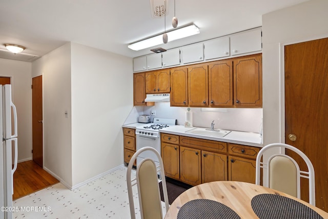 9D Dove St, Manchester, NJ 08759 - kitchen with a sink, white appliances, under cabinet range hood, light floors, and light countertops