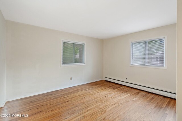 9D Dove St, Manchester, NJ 08759 - spare room featuring baseboard heating, light wood-style floors, and baseboards