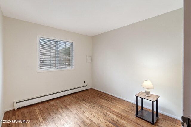 9D Dove St, Manchester, NJ 08759 - unfurnished room with baseboard heating, light wood-style floors, and baseboards