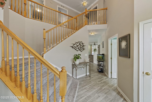 10 Butternut Ln, Bayville, NJ 08721 - stairs with ornamental molding, wood finished floors, baseboards, and a towering ceiling
