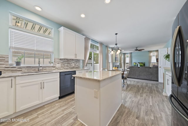 10 Butternut Ln, Bayville, NJ 08721 - kitchen featuring black dishwasher, freestanding refrigerator, tasteful backsplash, a sink, and recessed lighting