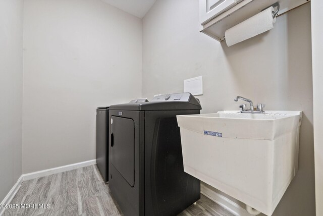 10 Butternut Ln, Bayville, NJ 08721 - laundry room featuring washing machine and dryer, light wood-style floors, and baseboards