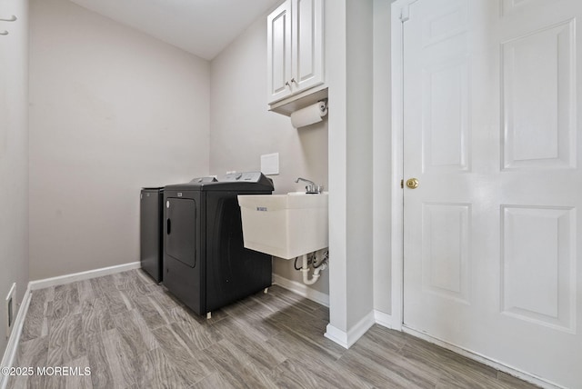 10 Butternut Ln, Bayville, NJ 08721 - washroom featuring separate washer and dryer, cabinet space, baseboards, and light wood-style floors