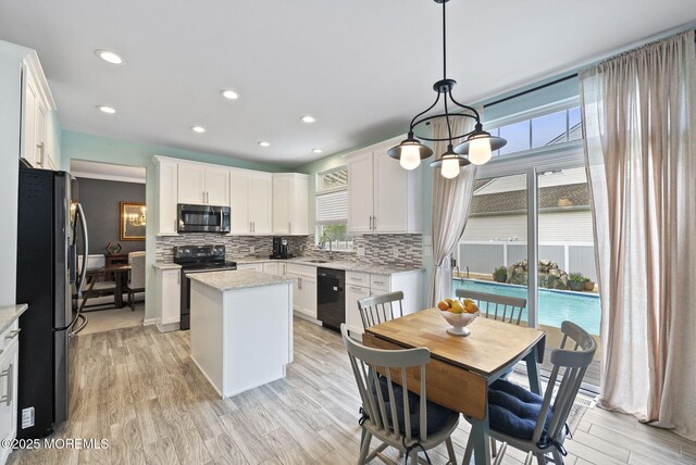 10 Butternut Ln, Bayville, NJ 08721 - kitchen featuring black appliances, a sink, healthy amount of natural light, decorative backsplash, and recessed lighting