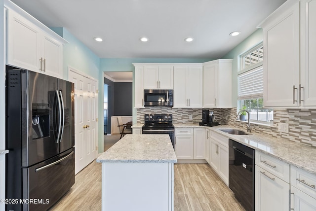 10 Butternut Ln, Bayville, NJ 08721 - kitchen with black appliances, a sink, a kitchen island, white cabinets, and recessed lighting