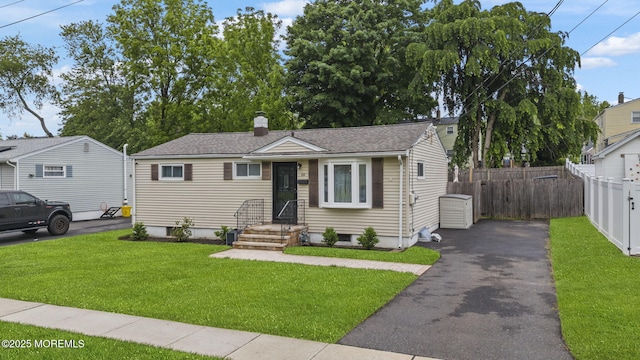 69 Helen Ave, Freehold, NJ 07728 - bungalow-style home with asphalt driveway, a chimney, and a shingled roof