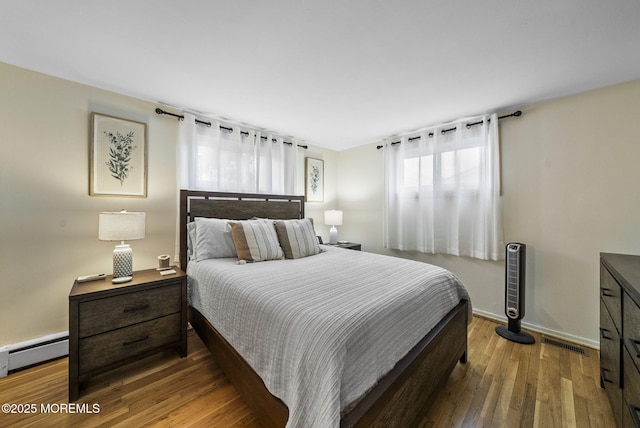69 Helen Ave, Freehold, NJ 07728 - bedroom with baseboard heating, wood finished floors, and baseboards