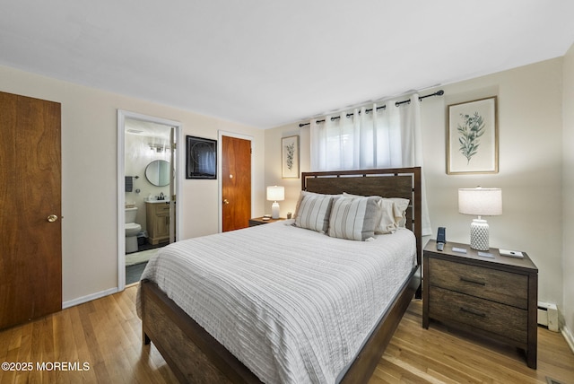 69 Helen Ave, Freehold, NJ 07728 - bedroom featuring wood finished floors, baseboards, a baseboard radiator, and ensuite bath