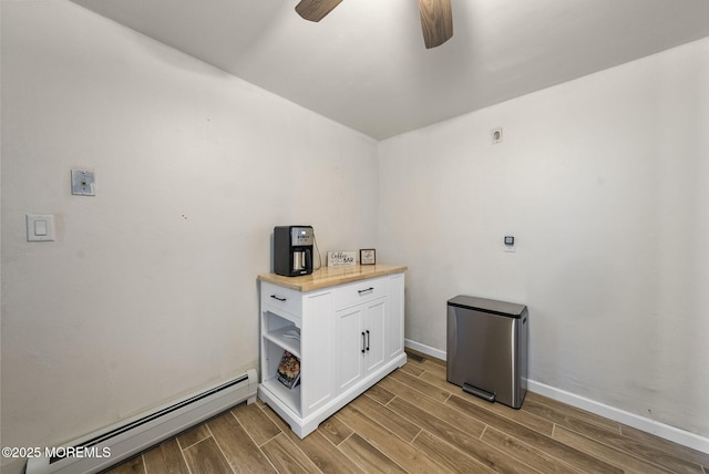 69 Helen Ave, Freehold, NJ 07728 - washroom featuring a baseboard heating unit, light wood-style flooring, baseboards, and ceiling fan