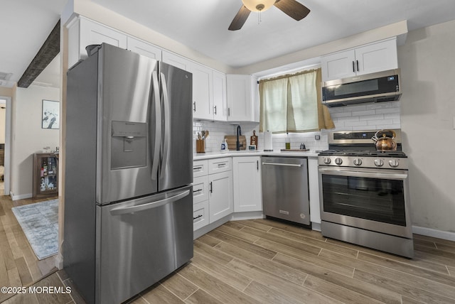 69 Helen Ave, Freehold, NJ 07728 - kitchen featuring stainless steel appliances, white cabinets, light wood-type flooring, and a ceiling fan