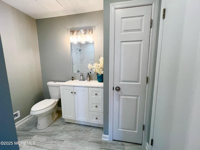 35 Wycoff Way E Unit 35, East Brunswick, NJ 08816 - bathroom with toilet, vanity, marble look tiles, baseboards, and a shower