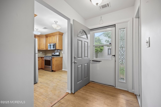 70 Lexington Cir, Matawan, NJ 07747 - foyer entrance with light wood finished floors and baseboards