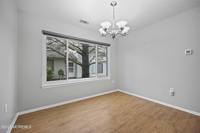 70 Lexington Cir, Matawan, NJ 07747 - spare room with a chandelier, wood finished floors, and baseboards