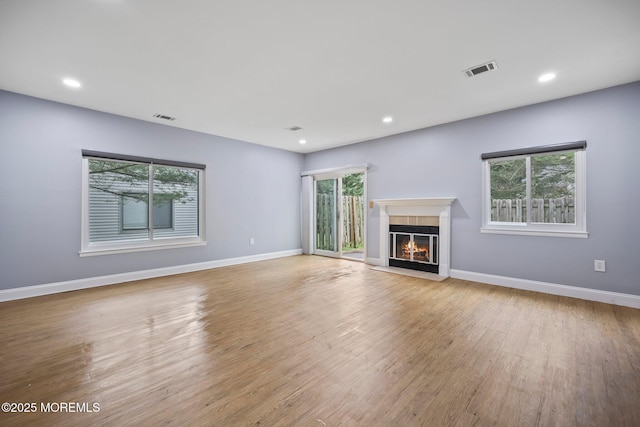 70 Lexington Cir, Matawan, NJ 07747 - unfurnished living room with wood finished floors, baseboards, a glass covered fireplace, and recessed lighting