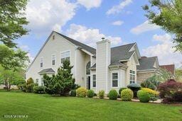 118 Timber Hill Dr, Monroe, NJ 08831 - back of property with a yard and a chimney