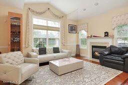 118 Timber Hill Dr, Monroe, NJ 08831 - living area with lofted ceiling, wood finished floors, and a glass covered fireplace