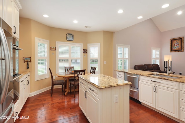118 Timber Hill Dr, Monroe, NJ 08831 - kitchen featuring appliances with stainless steel finishes, a sink, dark wood-type flooring, a kitchen island, and light stone countertops