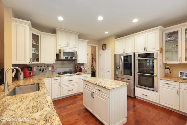 118 Timber Hill Dr, Monroe, NJ 08831 - kitchen with stainless steel appliances, a sink, backsplash, dark wood-style flooring, and light stone countertops